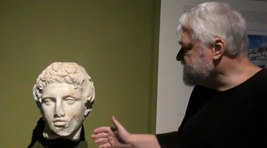 Writer Aleksei Meniailov studies the sculpture of an unnamed hero in the museum of the city of Burdur