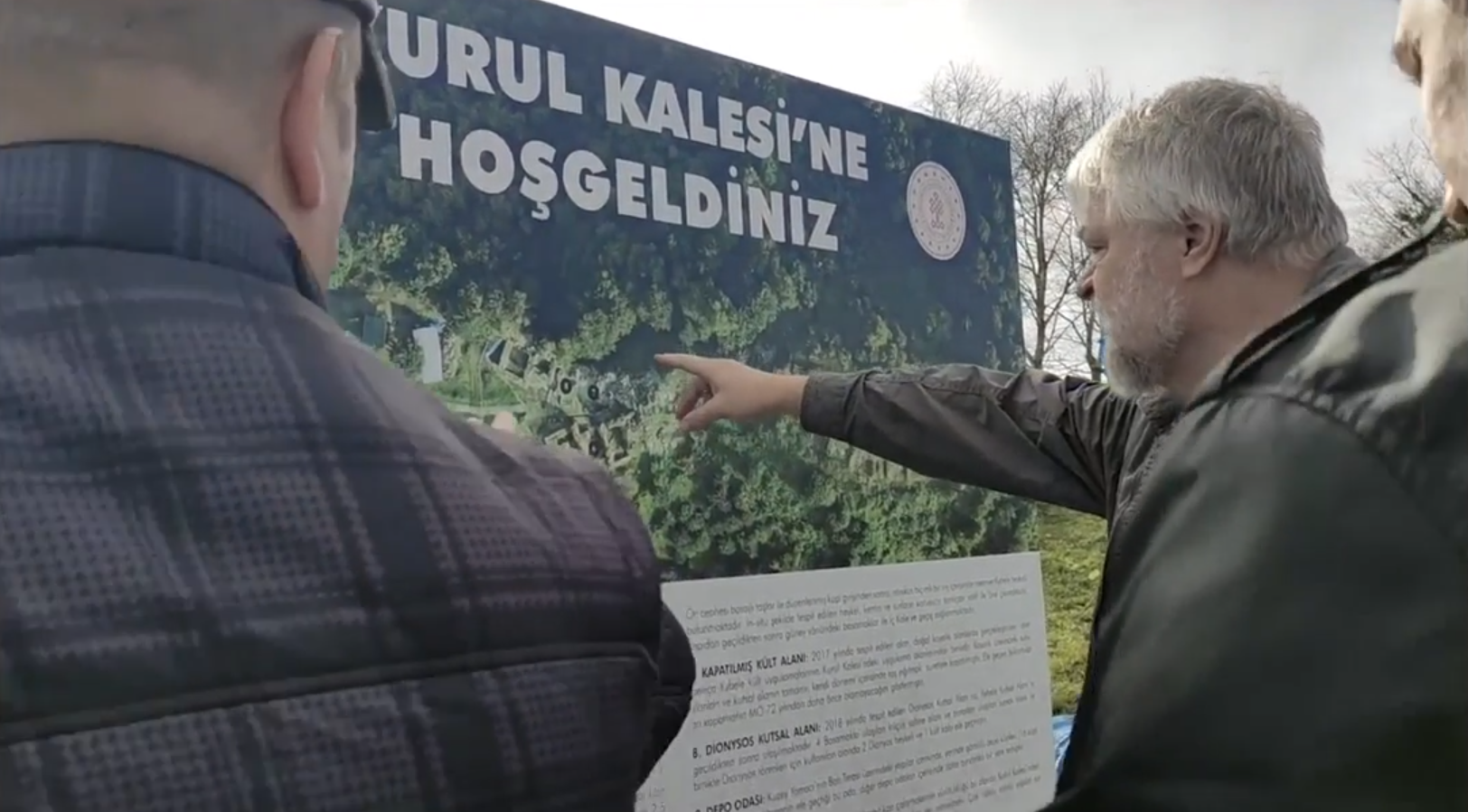 Writer Aleksei Meniailov studies a tourist map of the ruins of the Kurula castle during a joint trip with readers around the city of Ordu