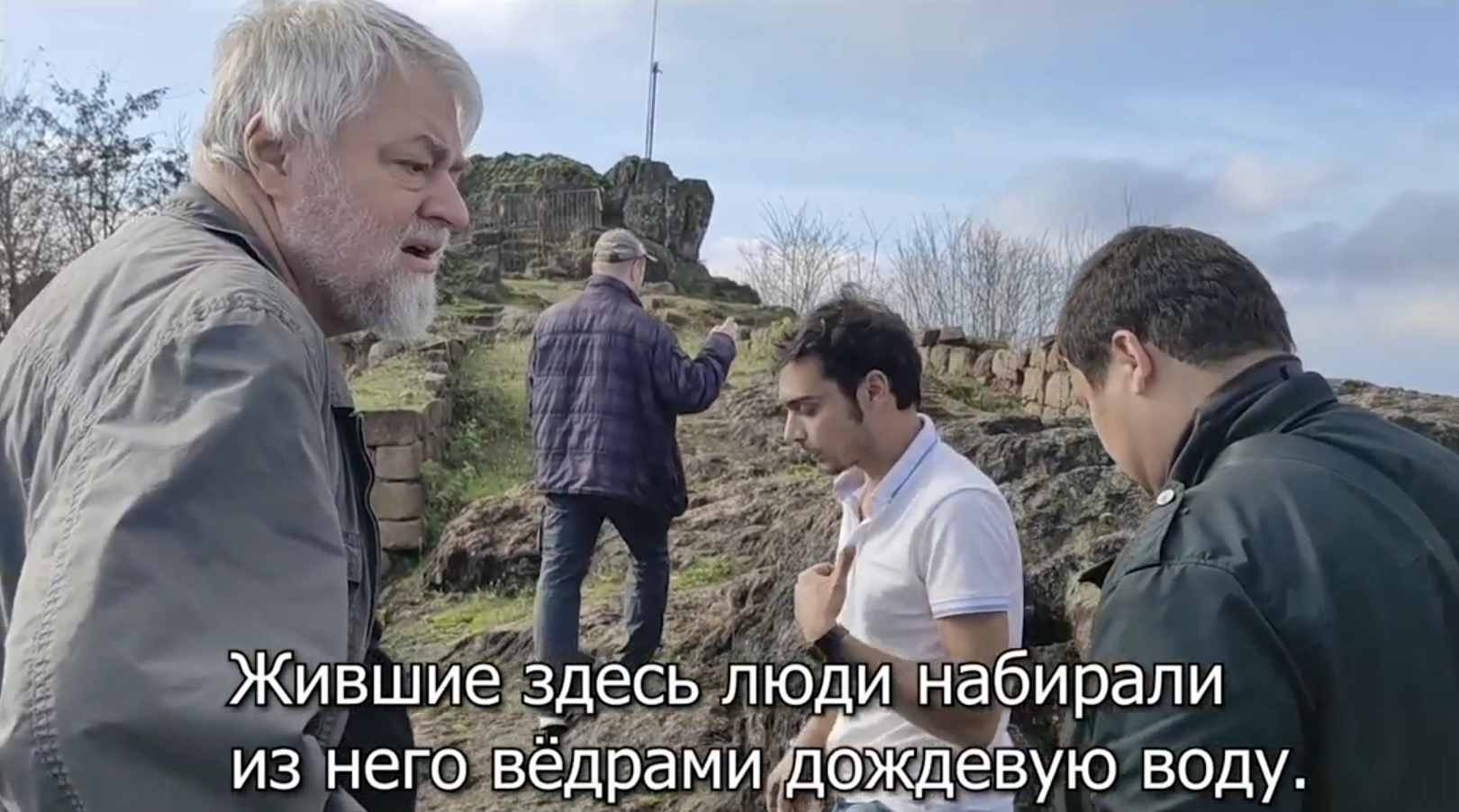 Writer Aleksei Meniailov and his readers on a guided tour of Kurul Castle. An image from the video "Cybele on the Rock of the Council"