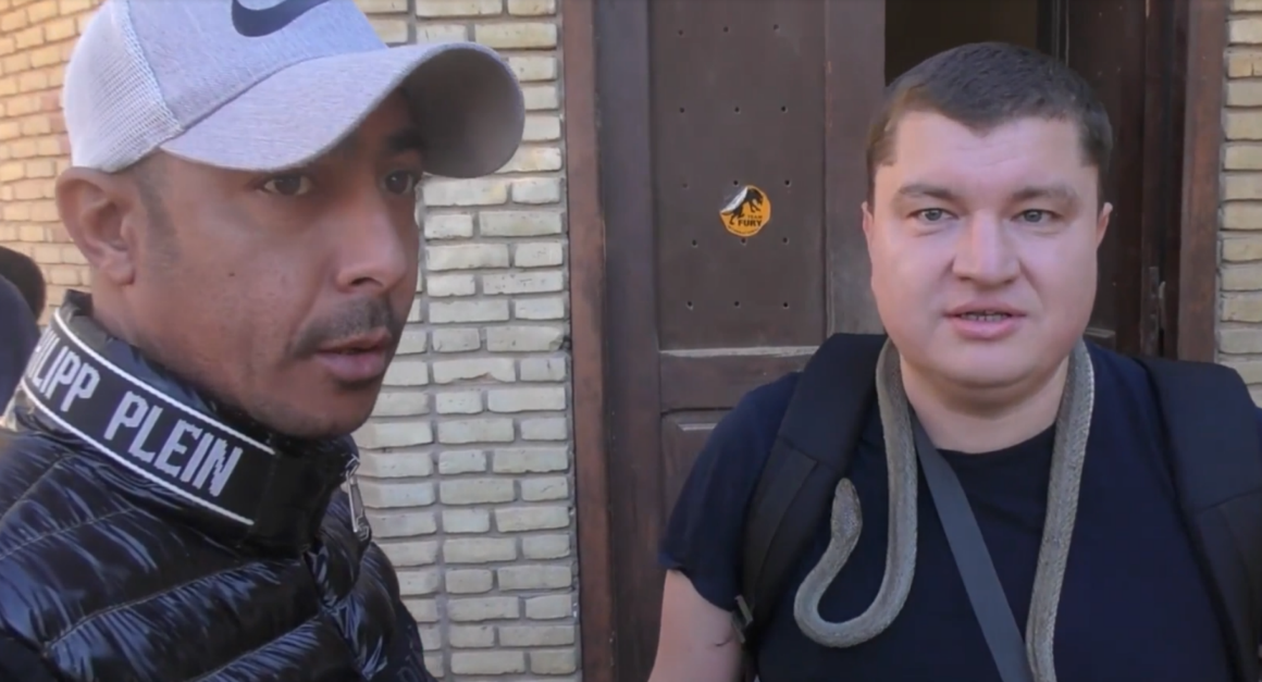 A reader of Aleksei Meniailov at the Tozer Zoo is photographed next to the zookeeper during a joint trip to the zoo with the writer