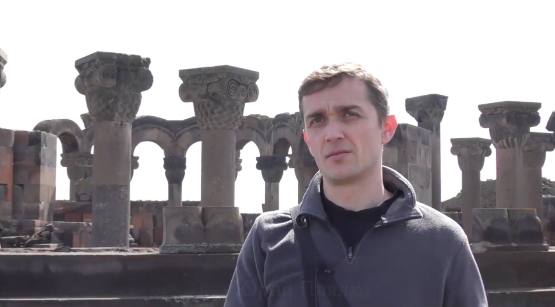 Aleksei Meniailov’s reader gives an interview during a visit to Zvartnots Church in the vicinity of Yerevan